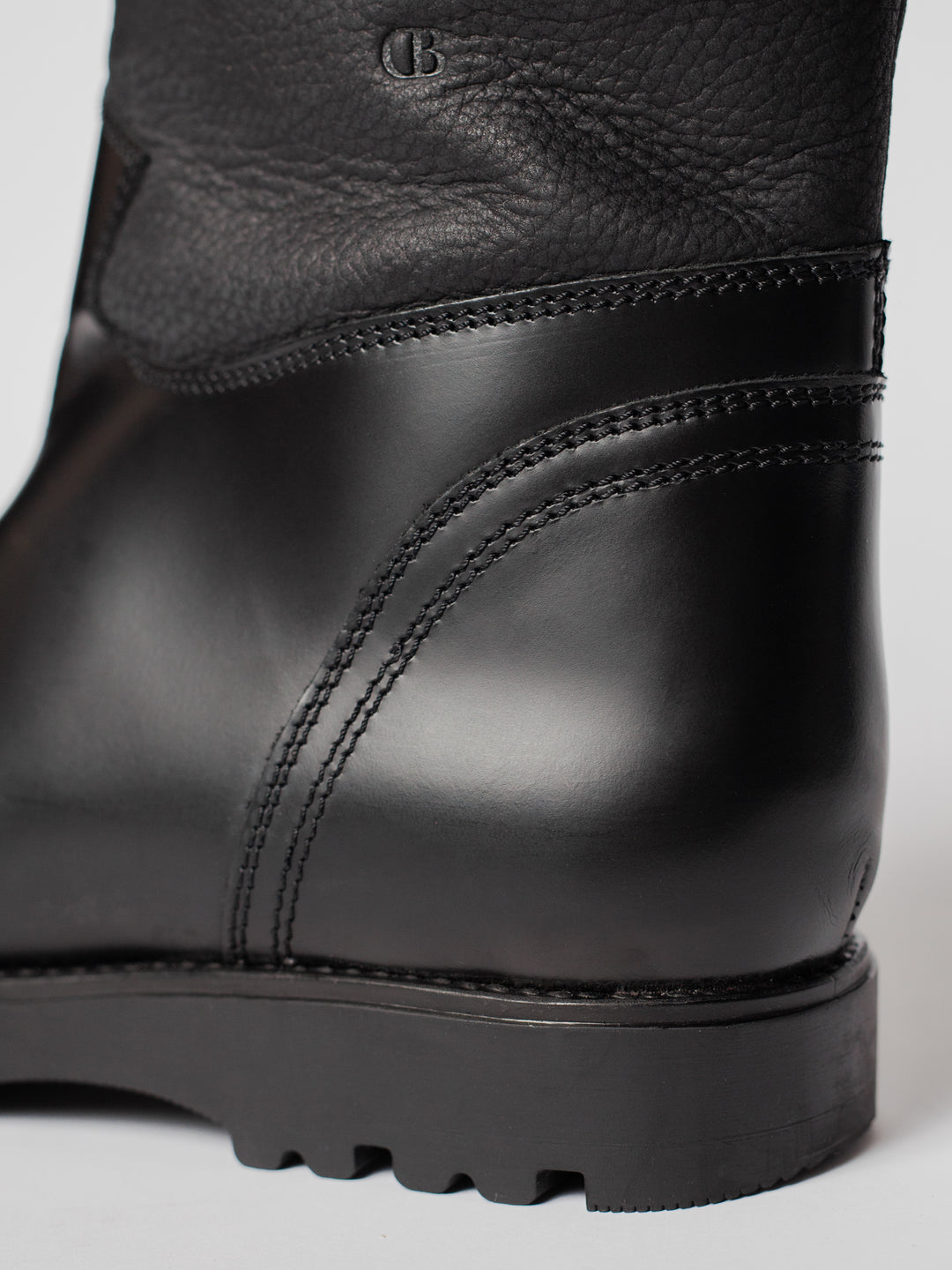 Blankens The Alexia Low Eco black low boot with handles. warm with fuzzy wool lining. water resistant. detail photo of the back with CB logo