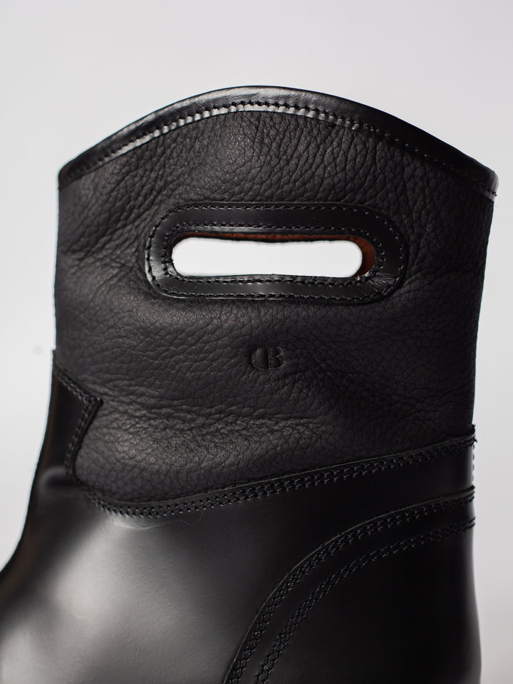 Blankens The Alexia Low Eco black low boot with handles. warm with fuzzy wool lining. water resistant. detail photo of the handle with CB logo