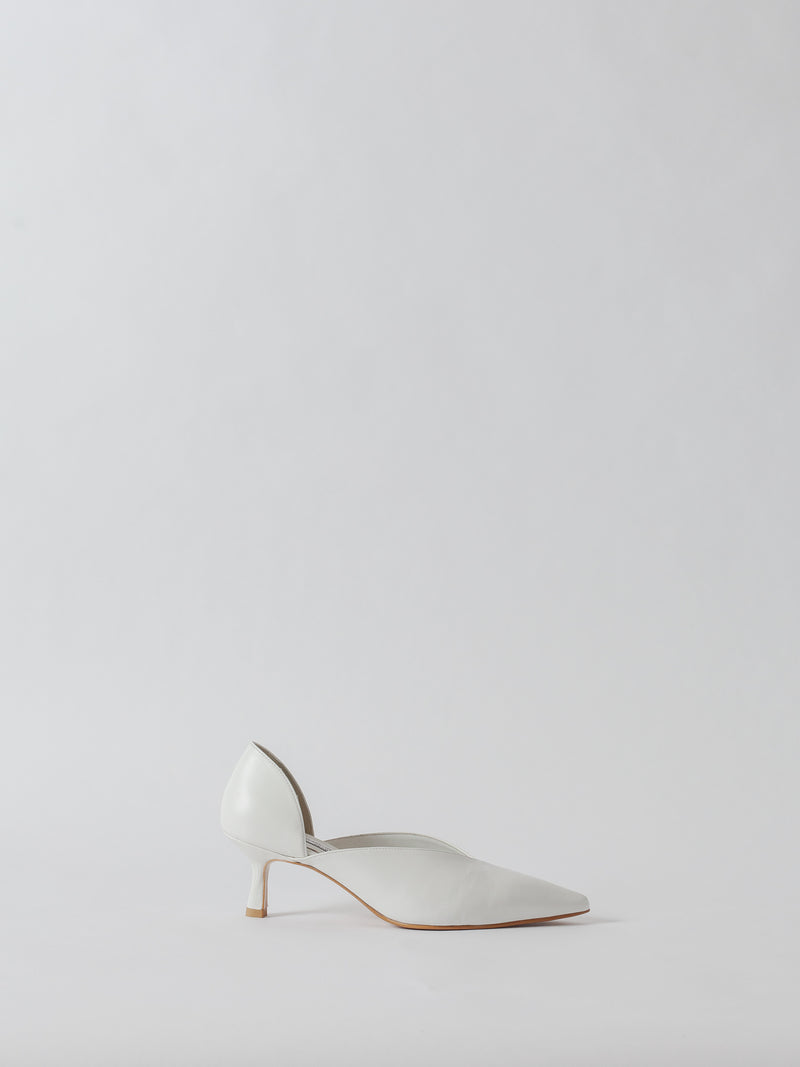 White high-heeled shoe on a light gray background