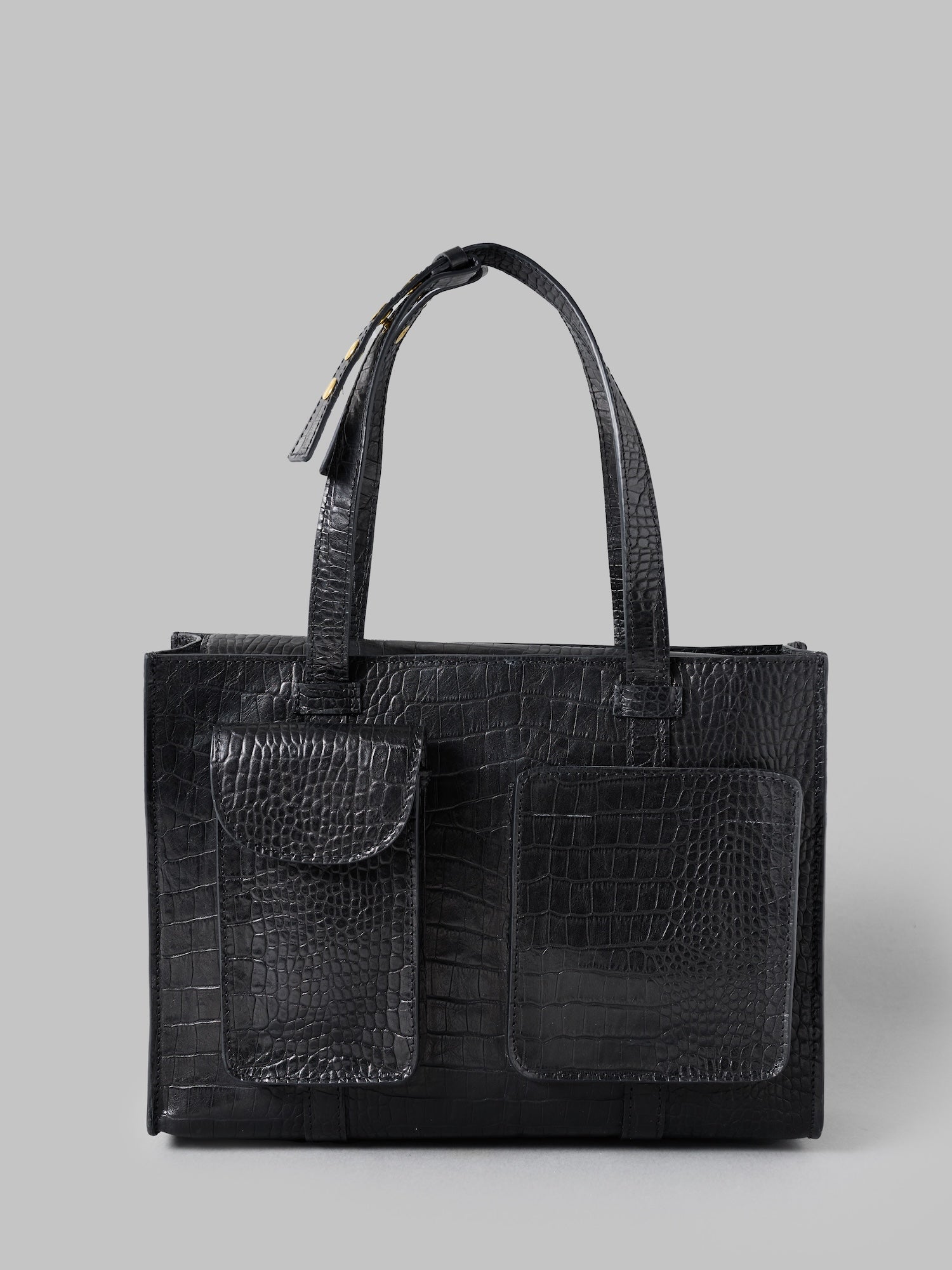 Black textured handbag on a gray background