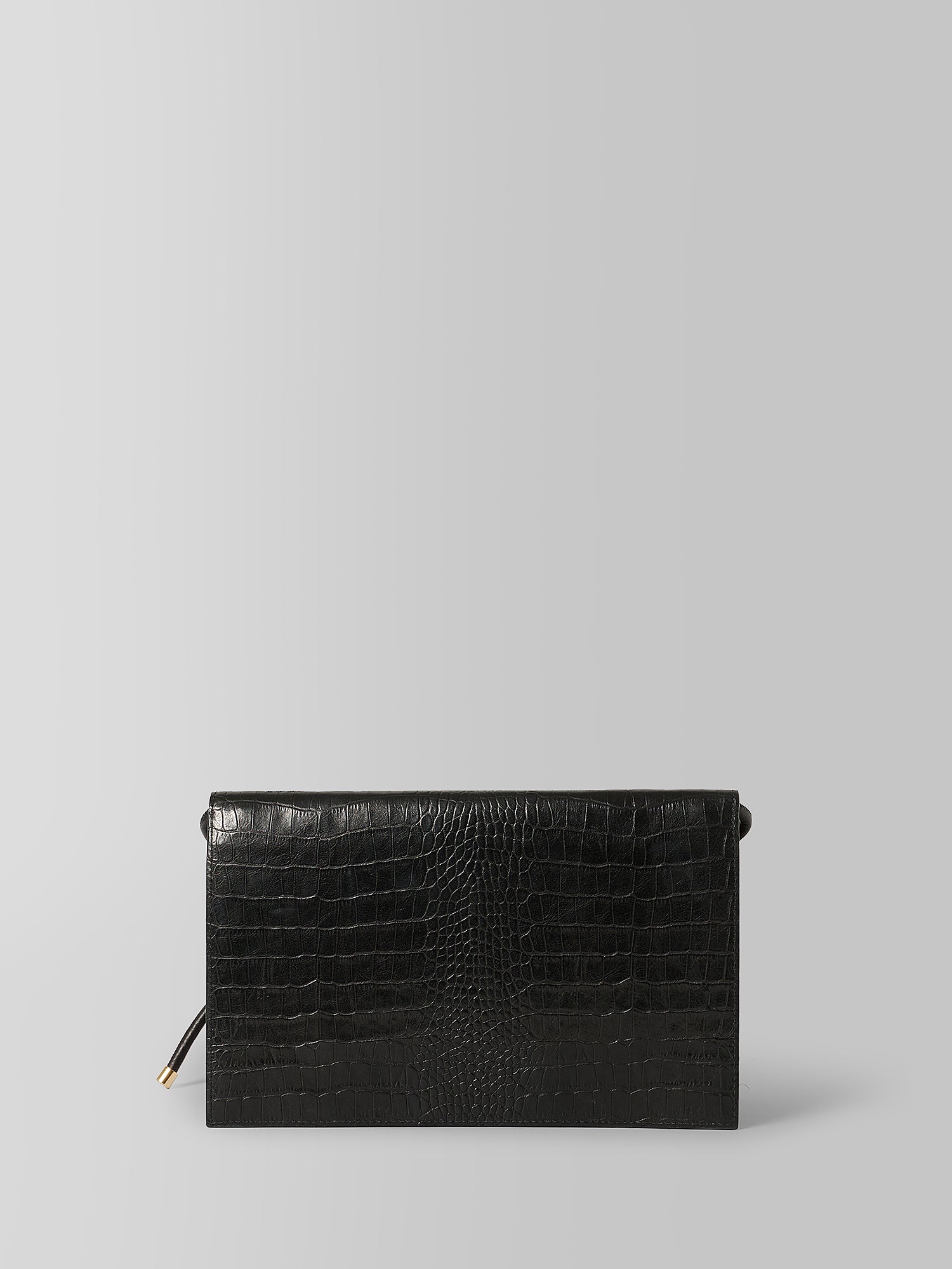 A black crocodile-embossed leather clutch bag with a small gold zipper pull, shown against a solid light gray background.
