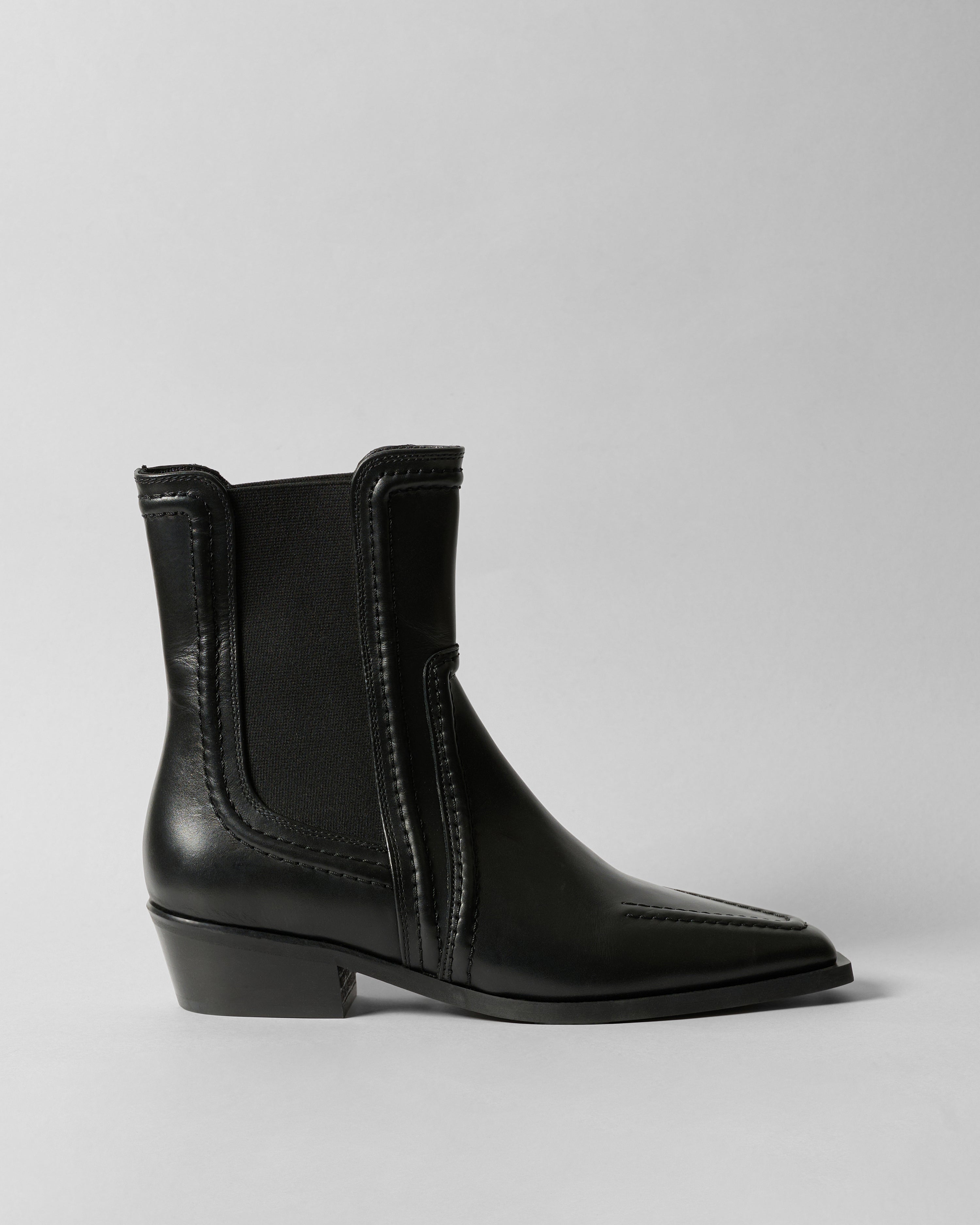 Black ankle boot on a light gray background