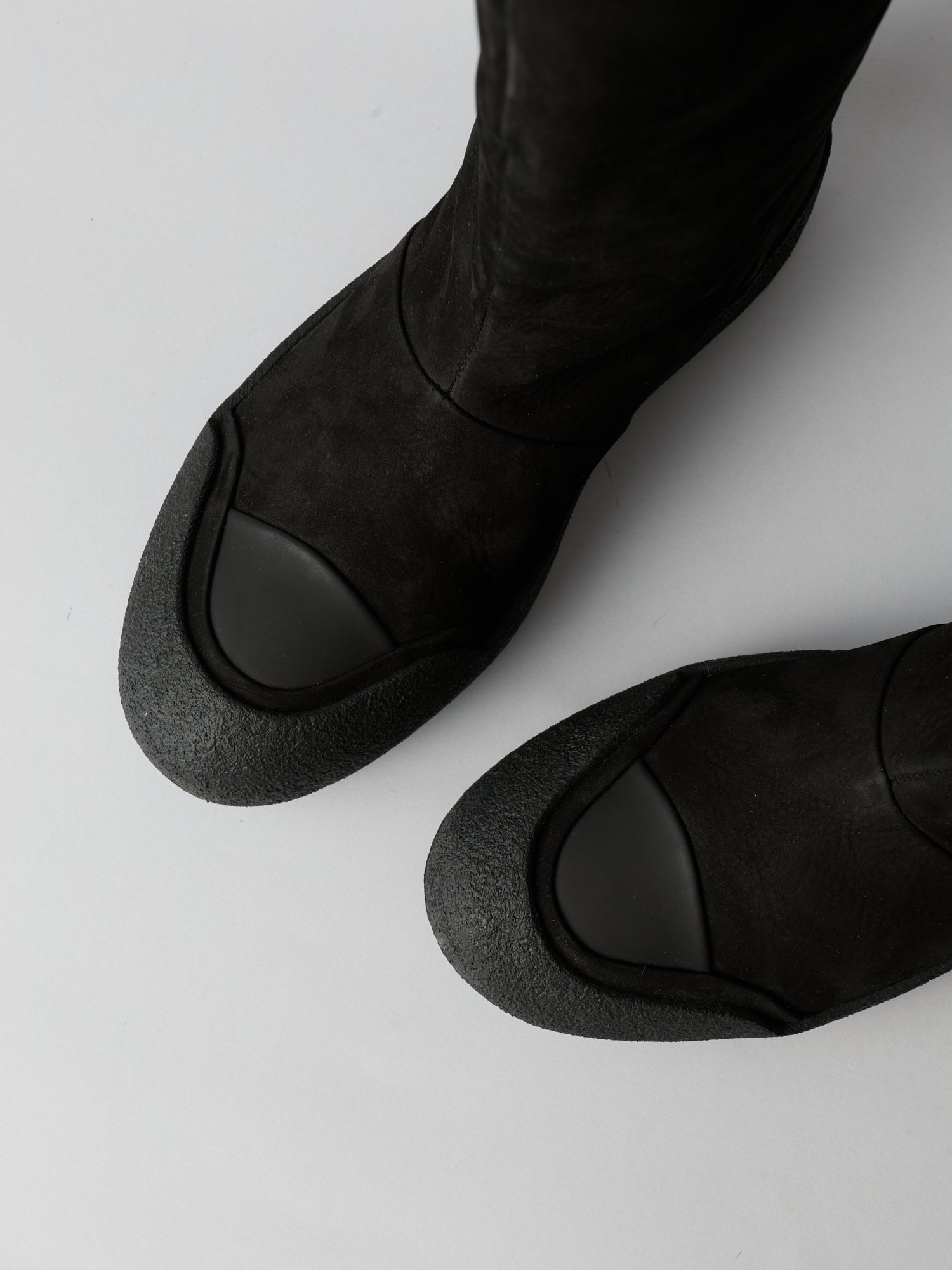 Black leather shoes on a light gray background