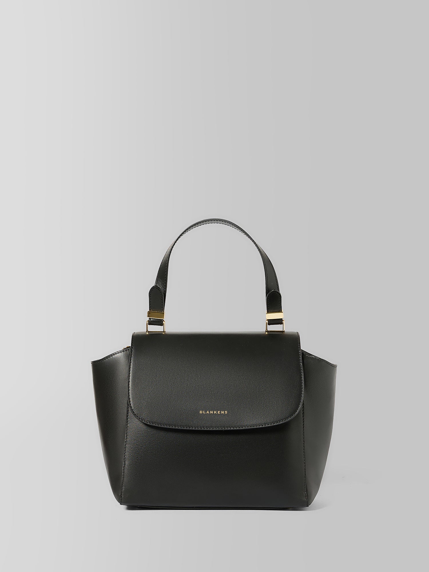 A black leather top-handle handbag with a structured silhouette, gold-tone hardware, and a small gold 'BURGA' logo on the front, shown against a neutral gray background.