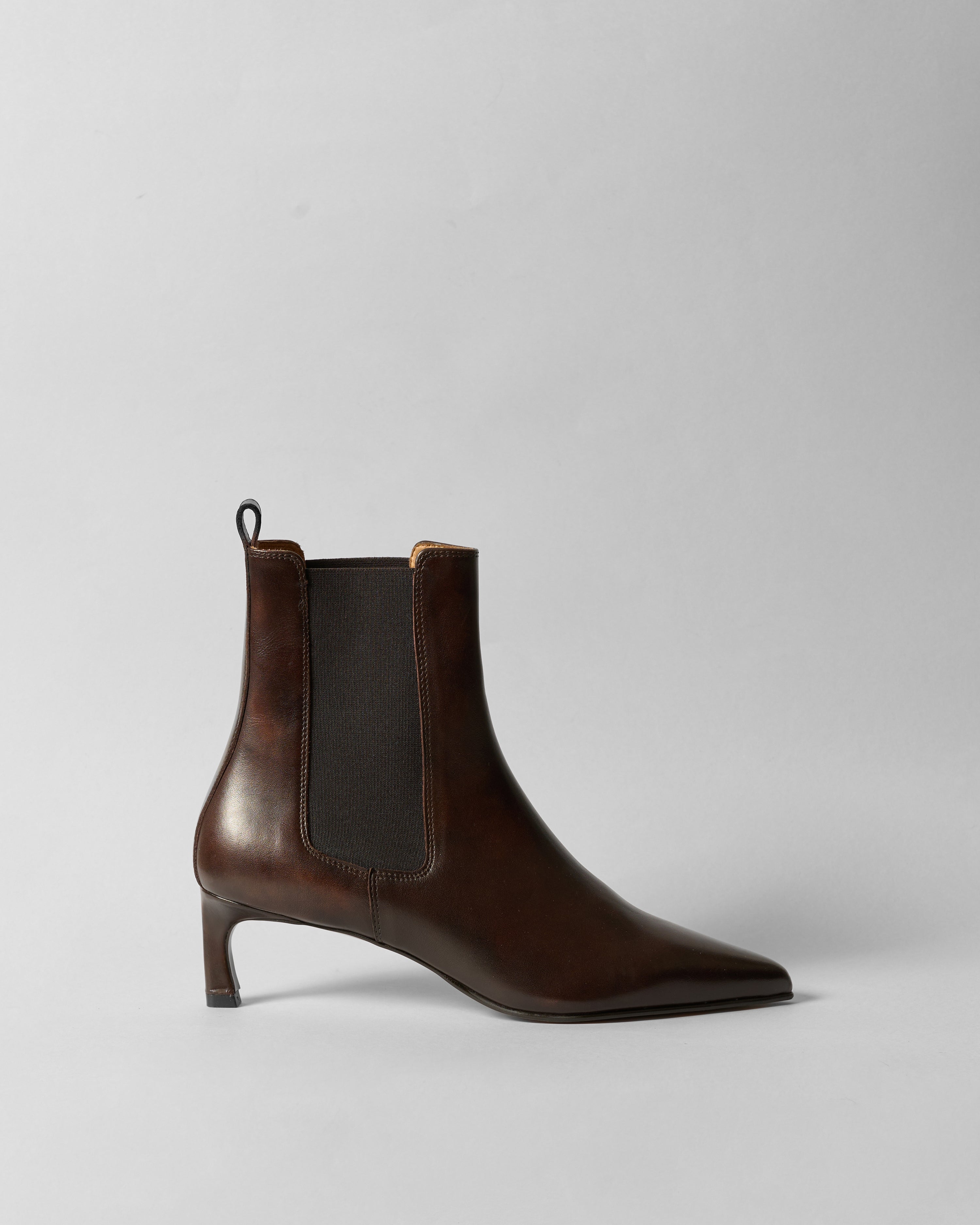 Brown leather ankle boot on a light gray background