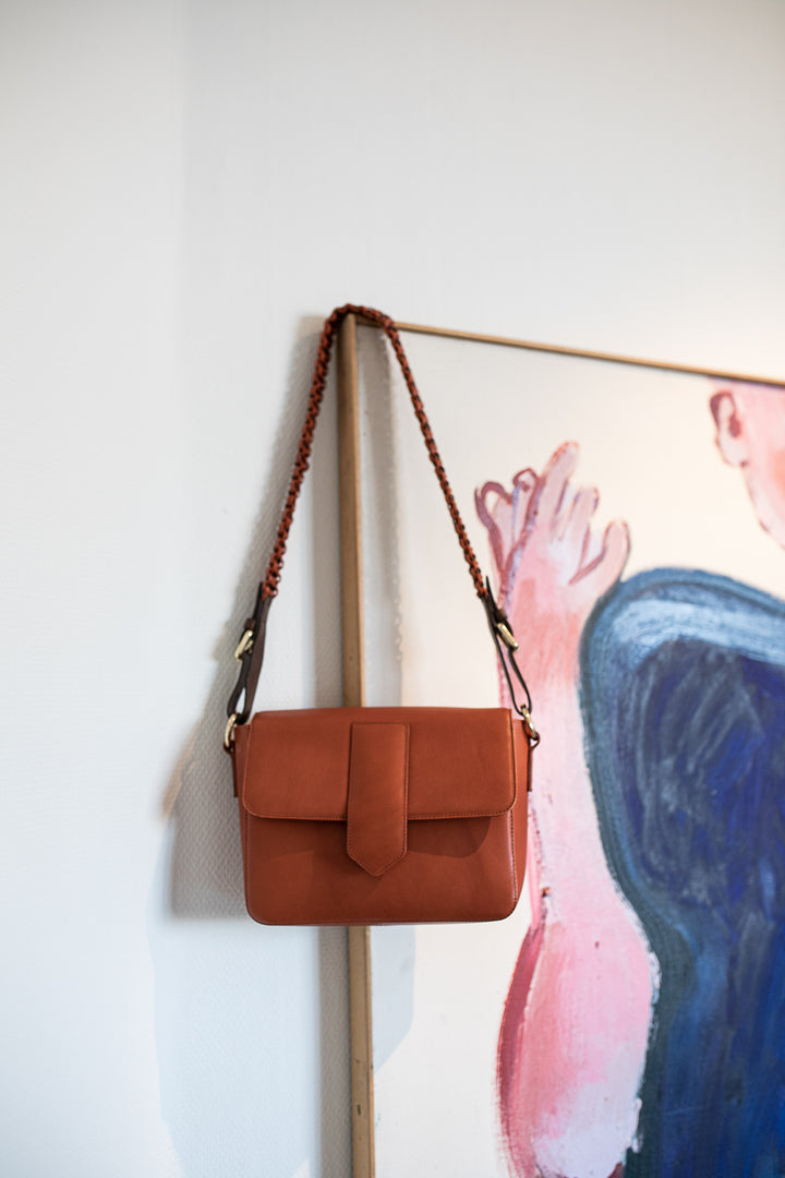 Blankens The Madeira bag orange/terracotta coloured bag leather hanging on a painting